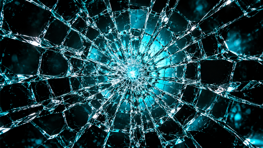 Cracked tempered glass pattern backlit by vivid cyan light on black