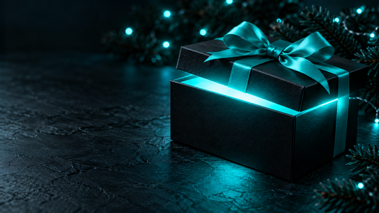 Black gift box with a cyan ribbon and a bright cyan glow coming from the open lid